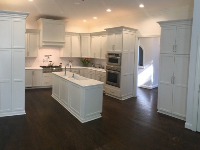 kitchen remodel with white cabinetry and dark wood floor