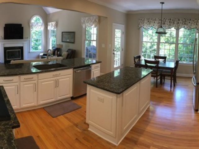 kitchen remodel with wood floors and black granite countertops