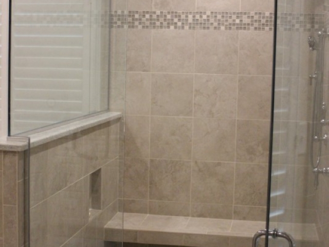 bathroom remodel shower with tile bench and glass doors